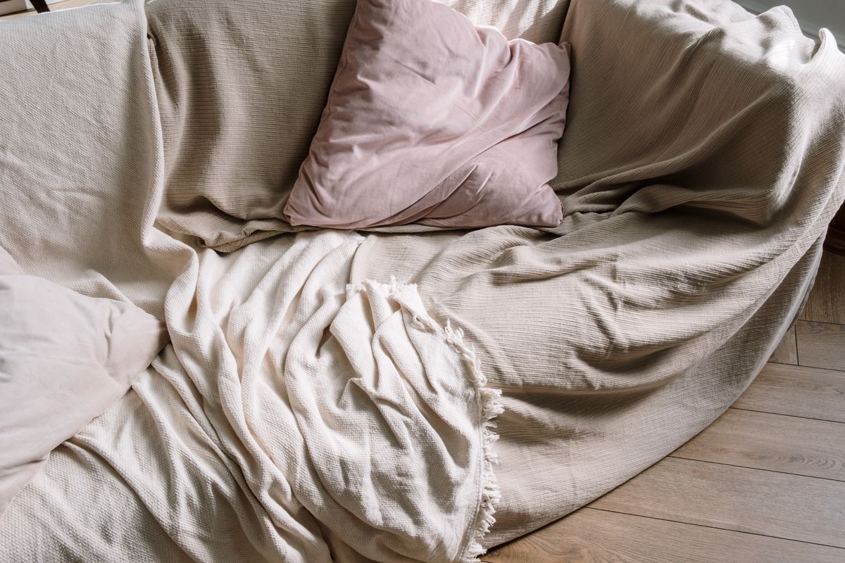 Throw and cushions on a beige sofa