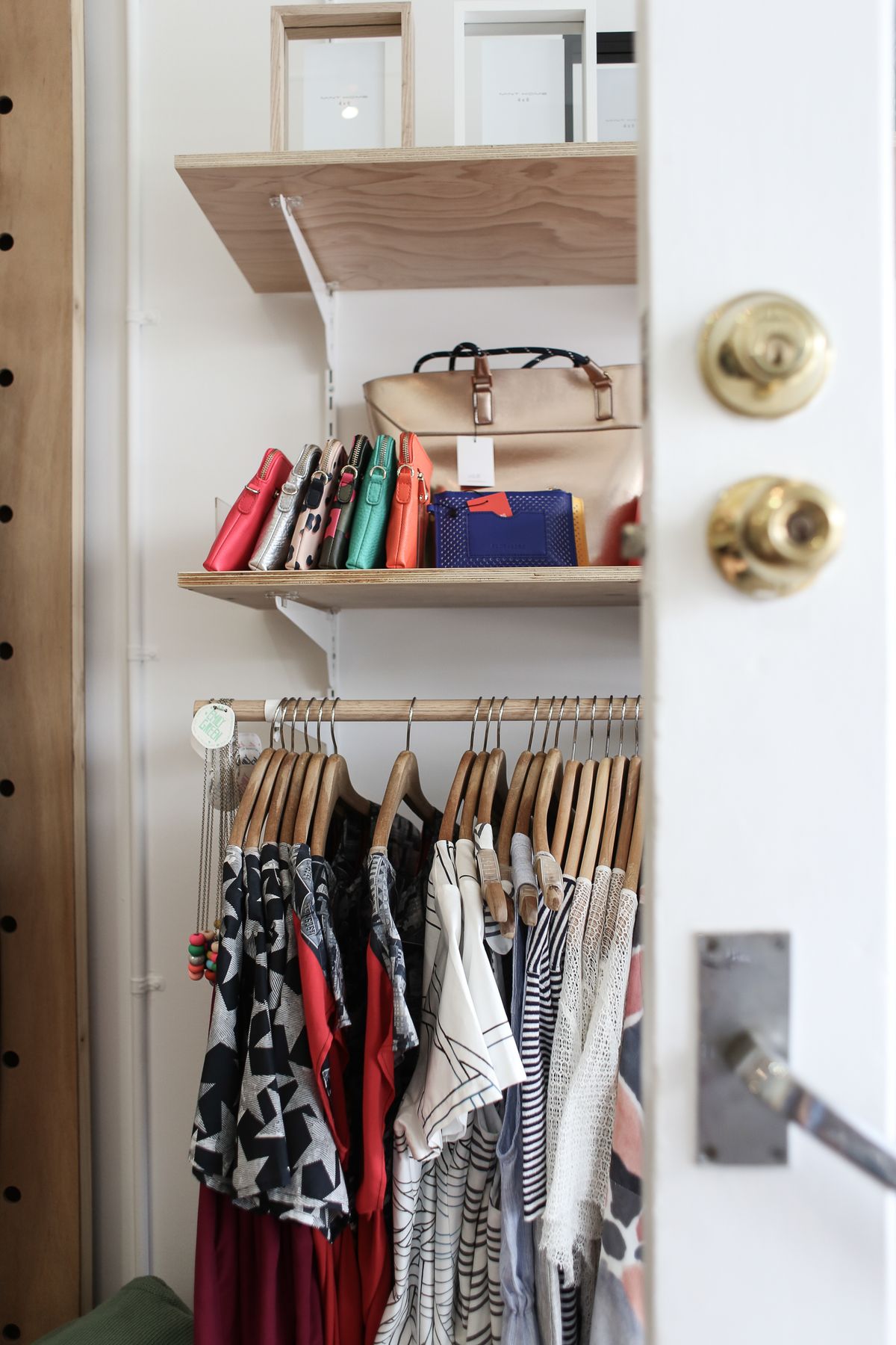 Clothes and bags organised in a wardrobe