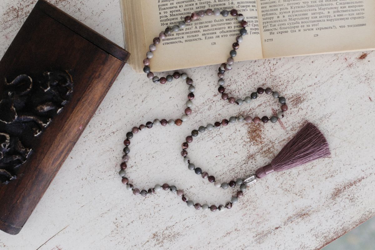 Necklace beside a wooden jewellery box