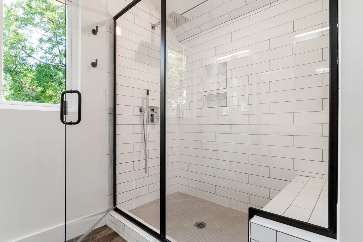 Glass shower enclosure in a bathroom