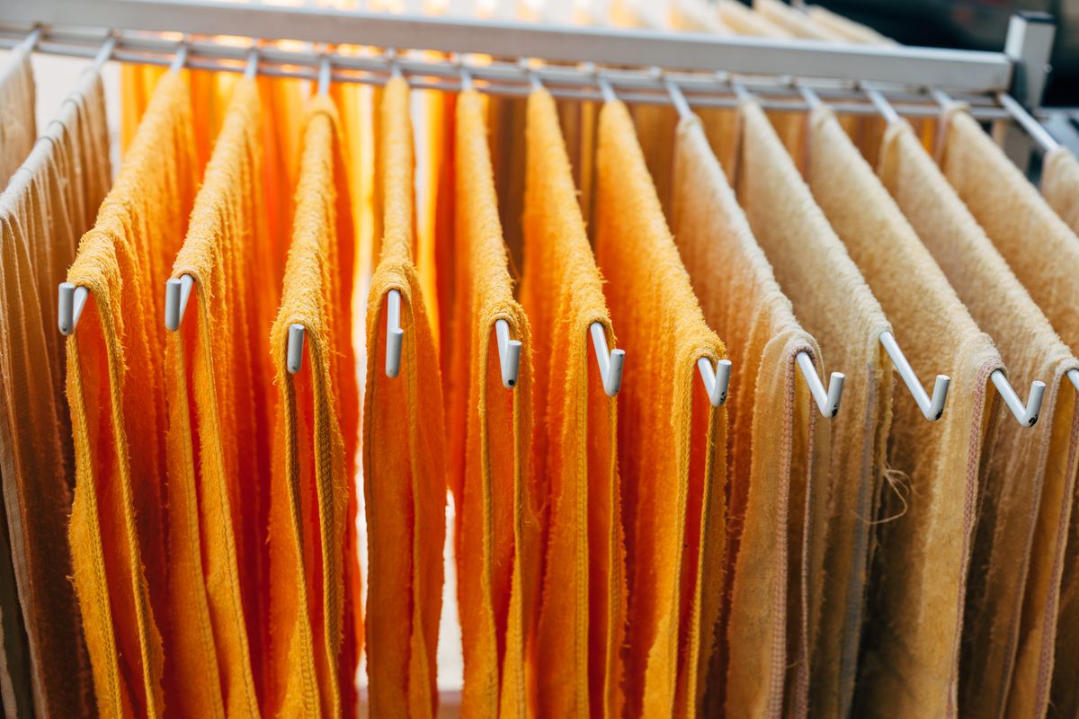 Towels spread out to dry on a rack