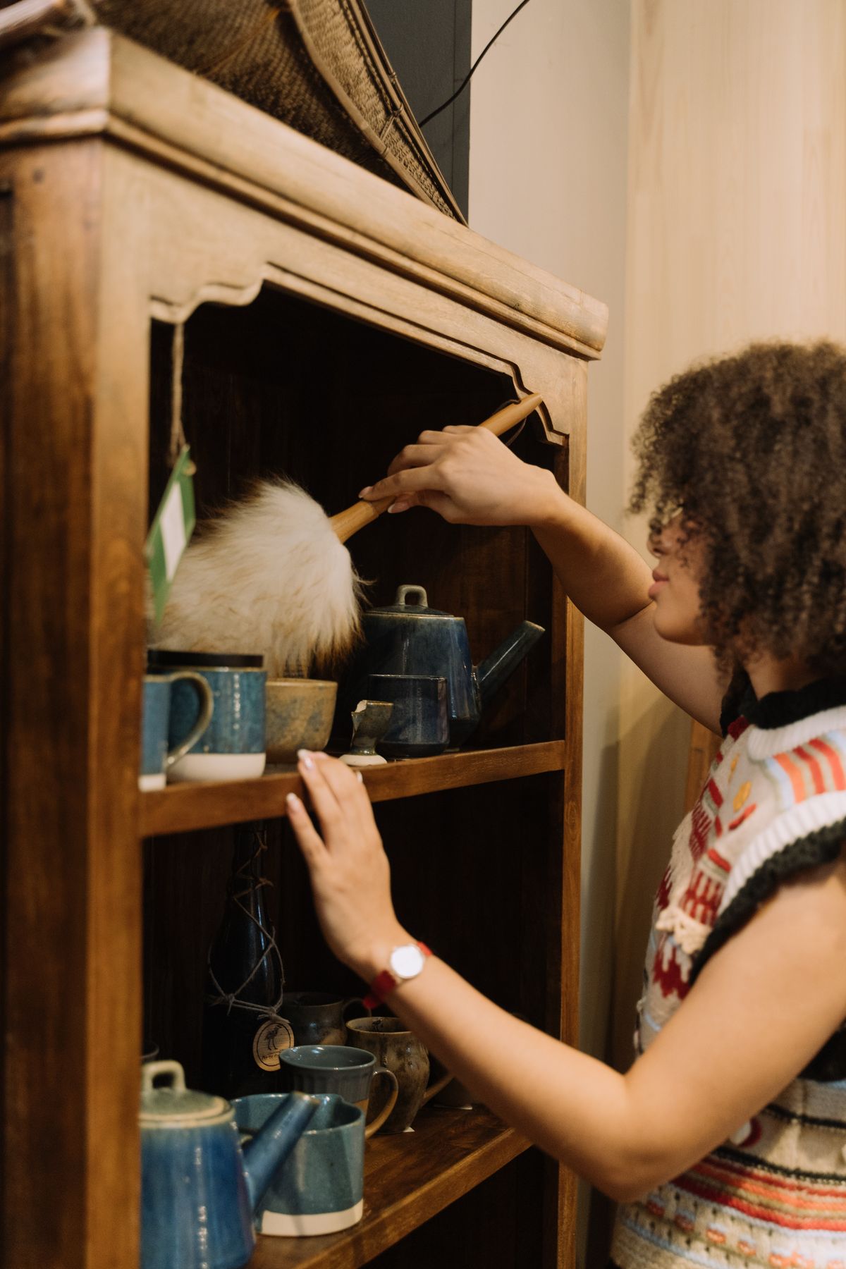 Dusting a wooden shelf