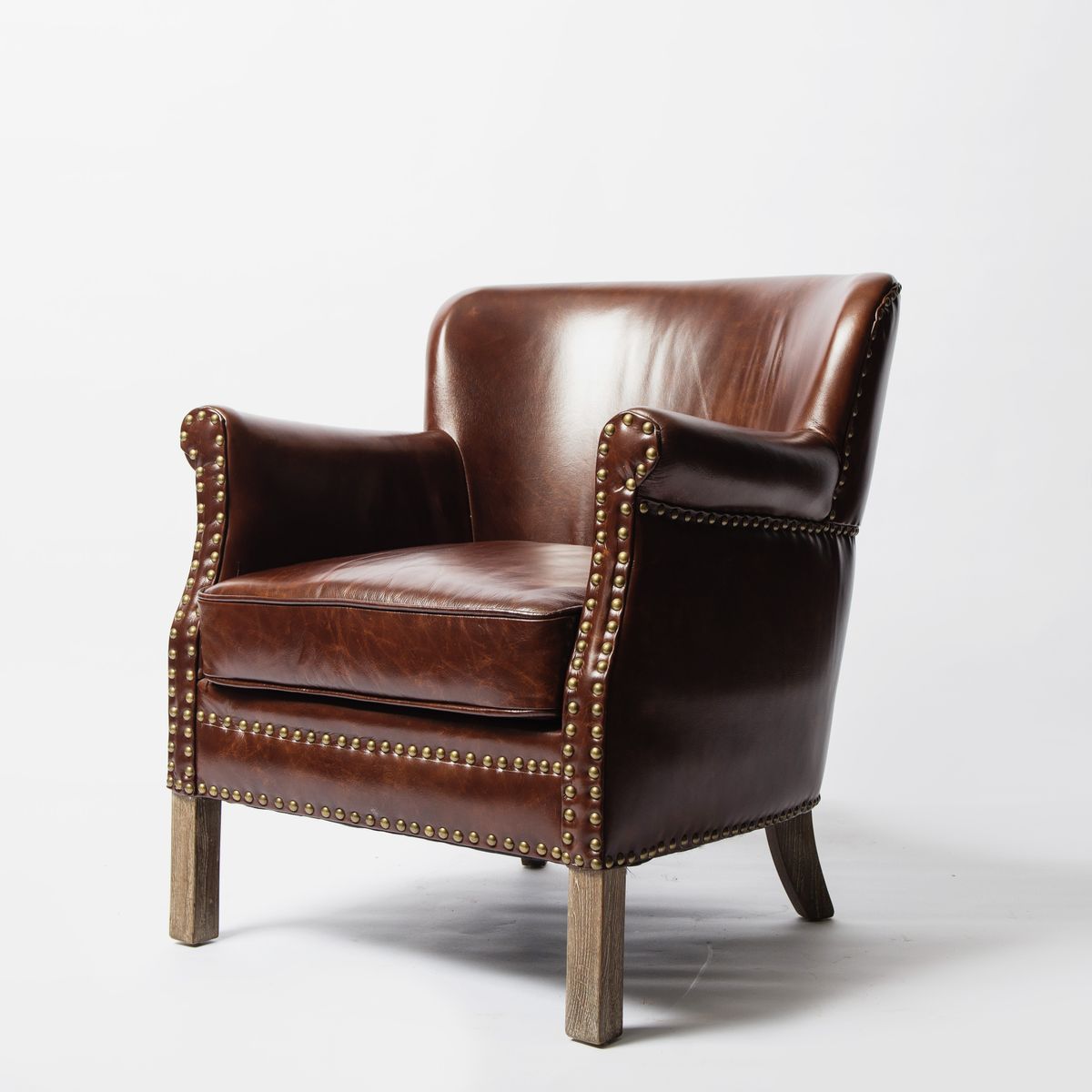 Brown leather armchair with wooden legs