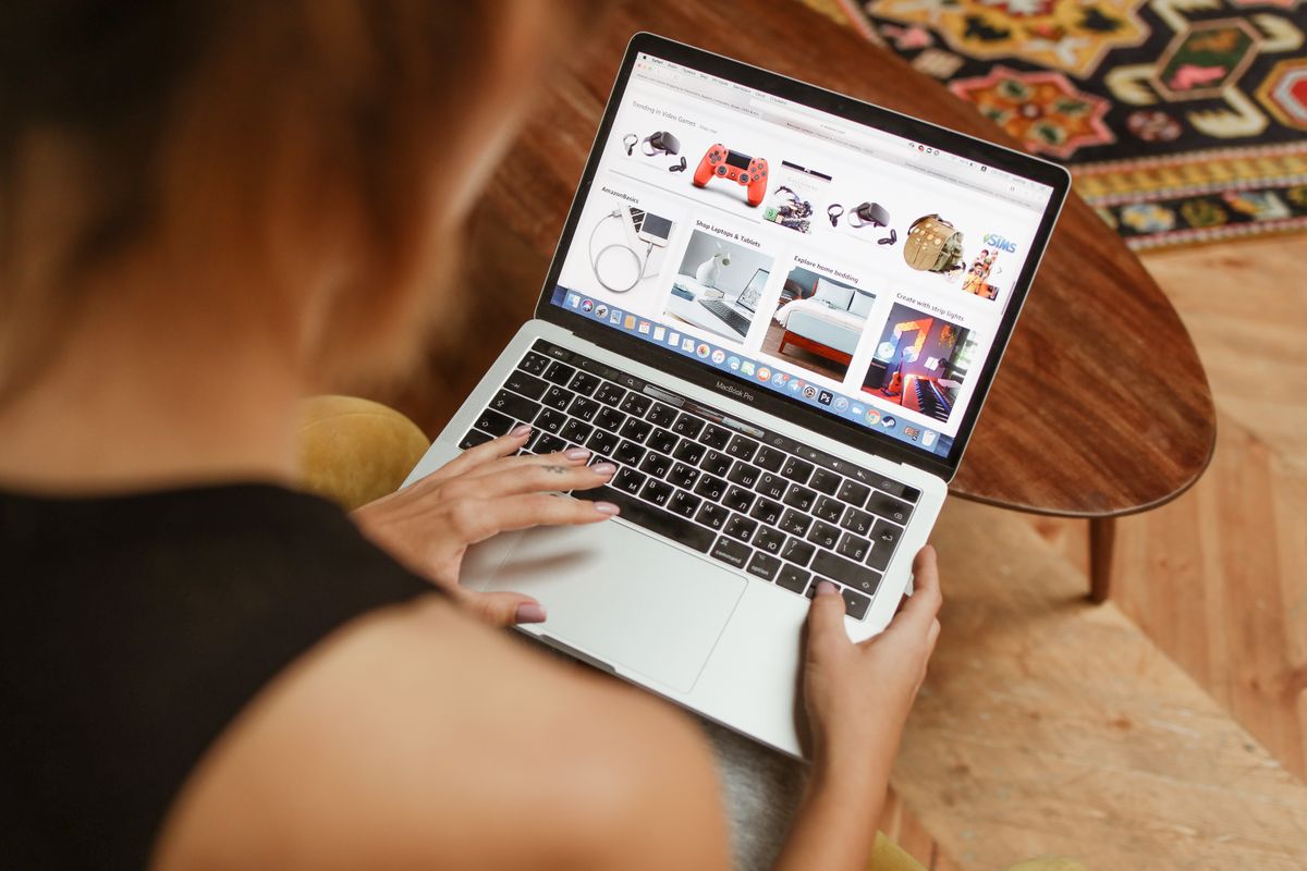 A person browses products on a laptop